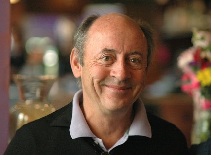 Head shot of poet Billy Collins with blurred background