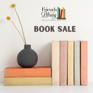 Book Sale, a decorative pot with two flowers sitting on two books perpendicular to five books.