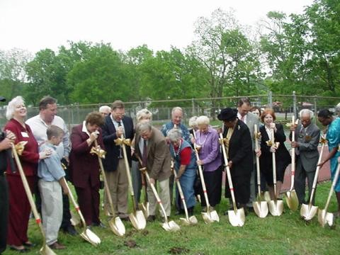 Photo of the library board, Friends of the Library, Library Director and prominent citizens breaking ground with gold shovels.